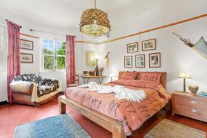 a bedroom with a large bed and a chair at Villa Les Dauphins in Le Lavandou