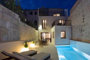 a villa with a swimming pool at night at Casa Sant Sebastia in Pollença
