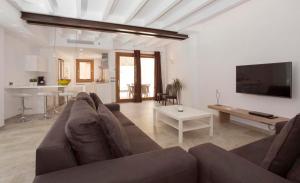 a living room with a couch and a table at Casa Sant Sebastia in Pollença