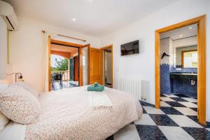 a bedroom with a bed and a checkered floor at Casa Campillos in Llucmajor +31 photos