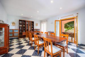a dining room with a wooden table and chairs at Casa Campillos in Llucmajor