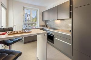 a kitchen with stainless steel appliances and a table at Ferienwohnung Stachel A in Konstanz