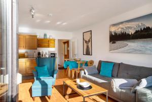 a living room with a couch and a table at Almzeit in Farchant