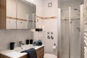 a bathroom with a sink and a shower at Almzeit in Farchant +16 photos