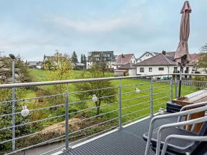 a balcony with a view of a field and houses at Zeiser in Pfullendorf