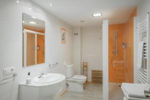 a white bathroom with a sink and a toilet at El Cedro in Abejar +28 photos