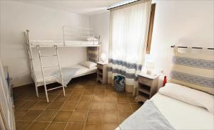 a room with two bunk beds and a tiled floor at Villa Ida Isuledda in San Teodoro +20 photos