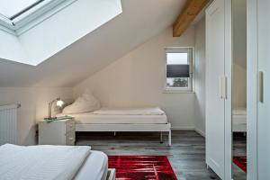 a white room with a bed and a window at Zeiser in Pfullendorf