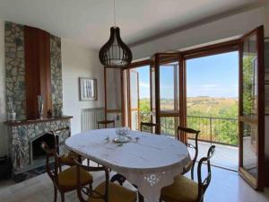a dining room with a table and chairs and a fireplace at Via Verdi 14 in Mondolfo