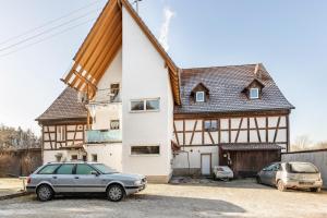 a house with a car parked in front of it at Gemütliches Appartament in Aldingen