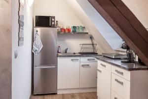 a kitchen with a stainless steel refrigerator at Gemütliches Appartament in Aldingen