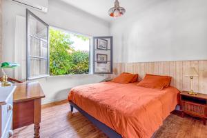 a bedroom with a large bed and a window at Maison de pecheur Arcachon in Arcachon