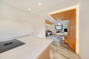 a kitchen with a counter top and a living room at Roda A Parte in Vigo di Fassa