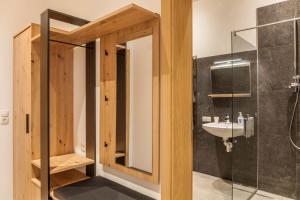 a bathroom with a shower and a sink at Kwelle zur Natur Rehwiese in Obernberg am Brenner +24 photos