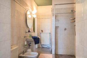 a bathroom with a toilet and a sink and a shower at Tinas yellow home in Leggiuno +16 photos