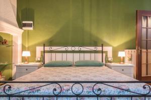 a bedroom with a large bed with two night stands at Tinas yellow home in Leggiuno