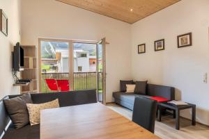 a living room with a couch and a table at Kwelle zur Natur Rehwiese in Obernberg am Brenner
