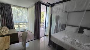a bedroom with a bed and a large window at joyful the Kris202 in Ban Lum Fuang
