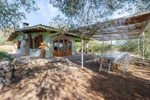 a table and chairs in front of a house at La Xaconera in Catllar