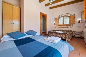 a bedroom with two beds and a mirror at La Xaconera in Catllar +28 photos