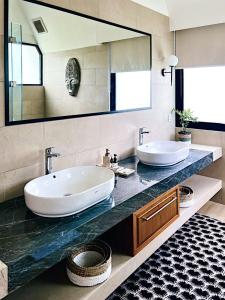 a bathroom with two sinks and a large mirror at Buyan Lakeside Villas in Bedugul +18 photos
