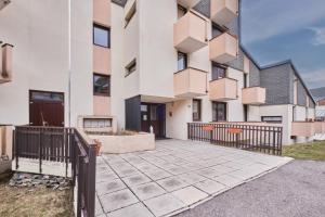 an apartment building with a walkway in front of it at Appartement Avec Balcon St Honore in Saint-Honoré