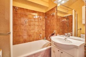 a bathroom with a sink and a bath tub and a sink at Appartement Avec Balcon St Honore in Saint-Honoré