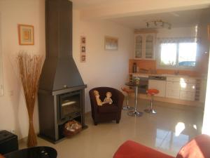 a living room with a chair and a fireplace at Gite bord de mer jacuzzi in Plougrescant