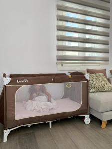 a baby in a crib in a room at Sofias House Fresh And Comfy in Naxos Chora