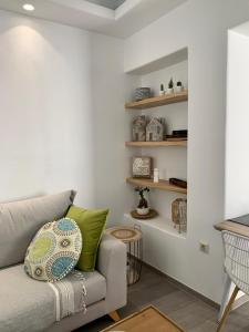 a living room with a couch and shelves at Sofias House Fresh And Comfy in Naxos Chora