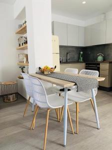 a kitchen with a table and chairs in a room at Sofias House Fresh And Comfy in Naxos Chora