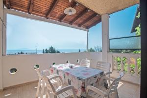 a dining room with a table and chairs at Andromaches apartment sea view in Corfu