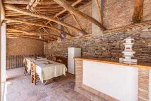 a dining room with a table and a refrigerator at Casa Juan y Loli in Nigüelas