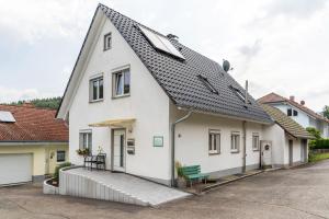a white house with a gray roof at Haus 23 in Ettenheim