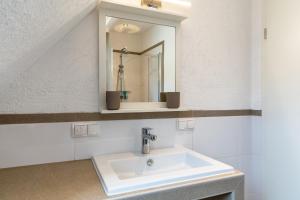 a bathroom with a sink and a mirror at Haus 23 in Ettenheim +21 photos