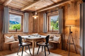 a dining room with a table and chairs and windows at Chalet’s Samer in Sarntal