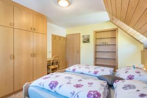 a bedroom with two beds and wooden cabinets at Oberwieserhof App 3 in San Lorenzo di Sebato +23 photos