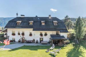 a large white house with a large yard at Oberwieserhof App 3 in San Lorenzo di Sebato