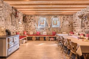 a kitchen with a long table and chairs in a room at Oberwieserhof App 3 in San Lorenzo di Sebato
