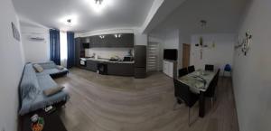 a large living room with a couch and a kitchen at Apart Alex in Constanţa