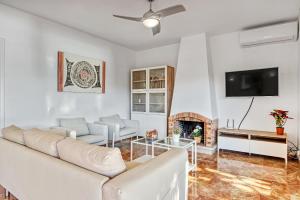 a living room with a couch and a fireplace at Perla del Mar Calpe in Benissa