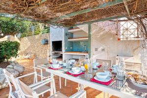 a dining room with a table with food on it at Perla del Mar Calpe in Benissa