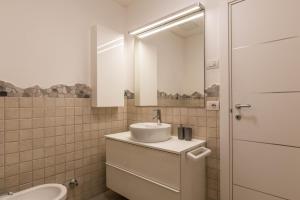 a bathroom with a sink and a mirror at Casa Weekend in Revò +14 photos