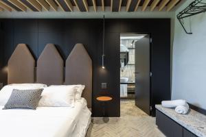 a bedroom with a large bed with a wooden headboard at Suite Cantina in San Gimignano