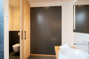 a bathroom with a toilet and a sink at Aura Chalets - Nr 2 in Castelrotto +26 photos