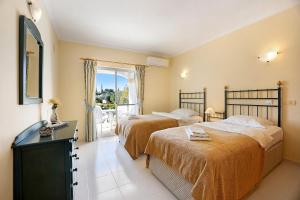 a hotel room with two beds and a balcony at Casa Primavera in Carvoeiro +29 photos
