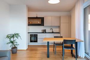 a kitchen and dining room with a table and chairs at Ferienwohnungen Karin - Lagrein in Termeno