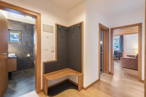 a room with a closet with a bench in it at La Grambla App Sella in Santa Cristina Gherdëina +25 photos