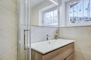 a bathroom with a sink and a window at Ciasa Christina - Attic in Moena +17 photos