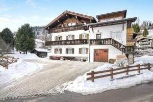 a large house in the snow with a fence at Ciasa Christina - Attic in Moena
